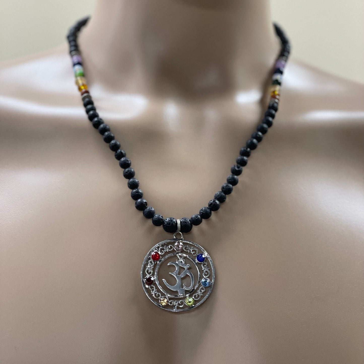 23.5” Stainless Steele Om Chakra Diffuser Necklace Adorned With 6mm Lava Stone Diffuser Beads & Chakra Stones (Amethyst, Lapis Lazuli, Opalite, Green Tigers Eye, Citrine, Amber, & Goldstone)