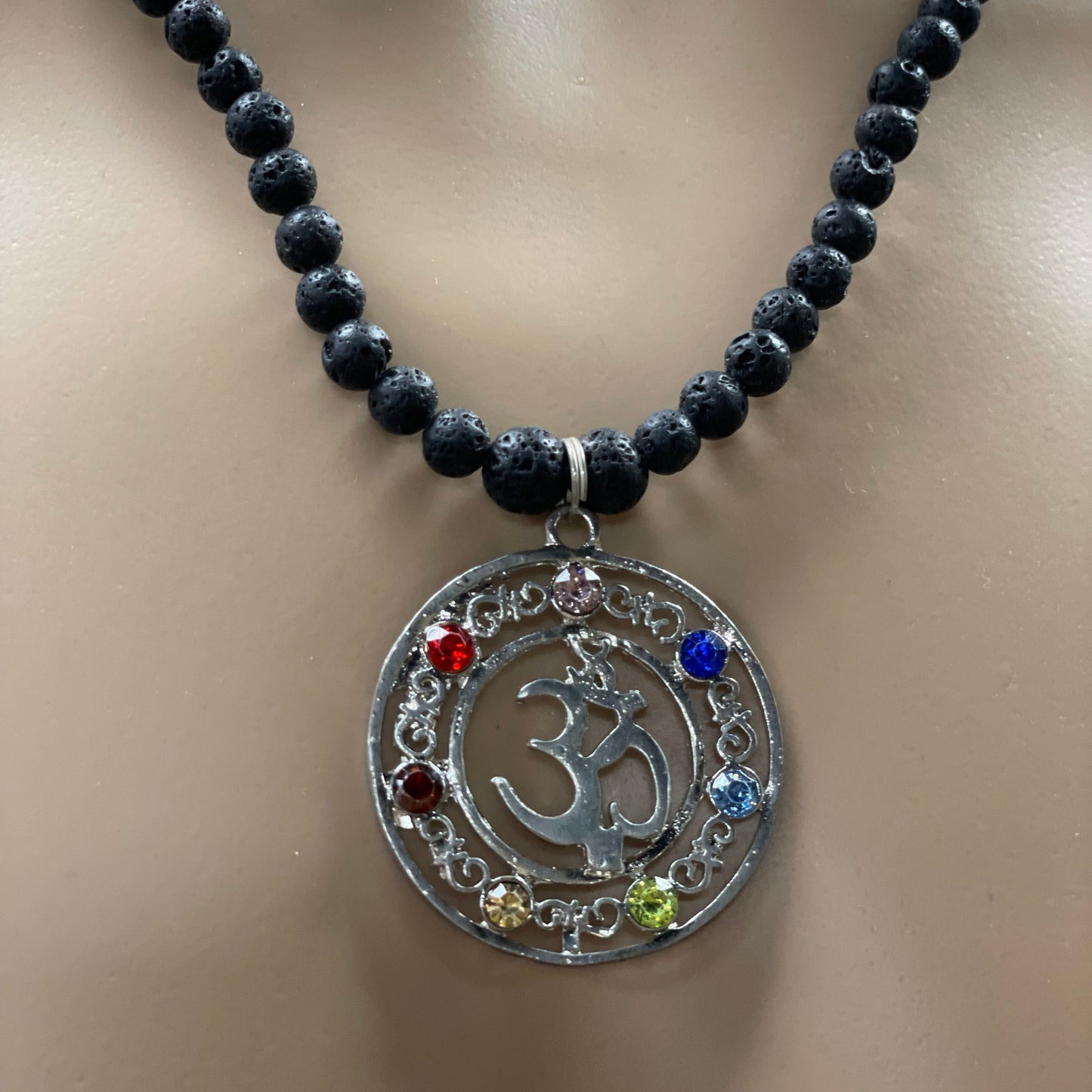 23.5” Stainless Steele Om Chakra Diffuser Necklace Adorned With 6mm Lava Stone Diffuser Beads & Chakra Stones (Amethyst, Lapis Lazuli, Opalite, Green Tigers Eye, Citrine, Amber, & Goldstone)