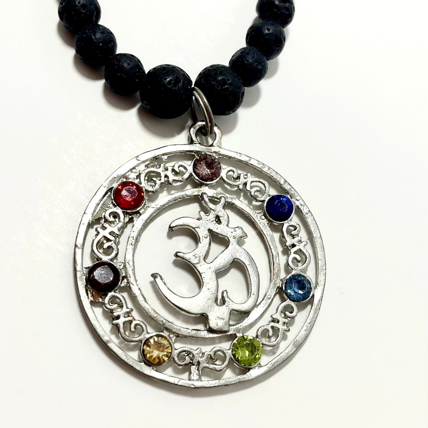 23.5” Stainless Steele Om Chakra Diffuser Necklace Adorned With 6mm Lava Stone Diffuser Beads & Chakra Stones (Amethyst, Lapis Lazuli, Opalite, Green Tigers Eye, Citrine, Amber, & Goldstone)