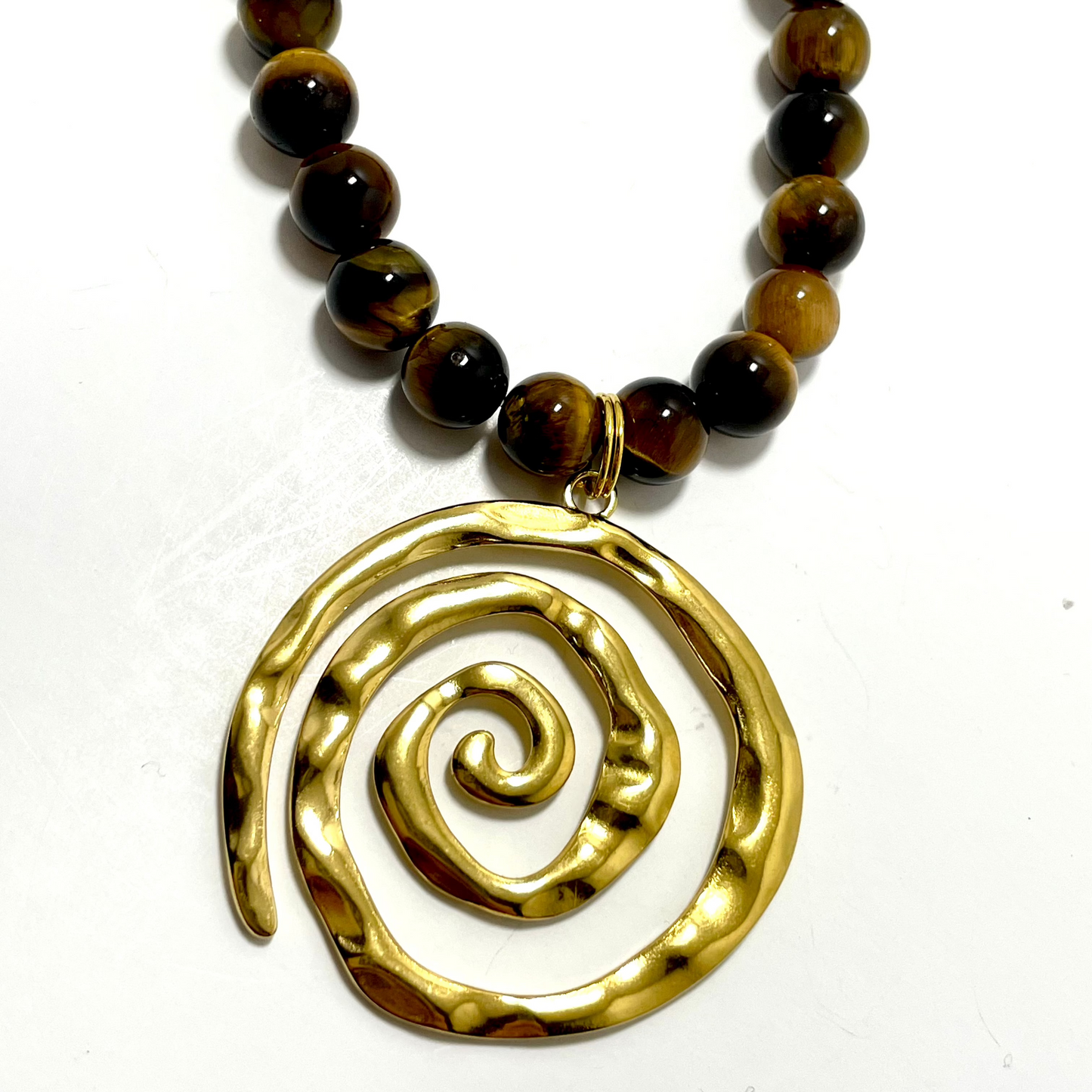 16” Gold Coated Stainless Steel Swirl Necklace Adorned With 8mm Tigers Eye Beads