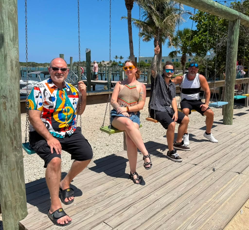 The whole Mad Mellow crew hanging out together on the dock swings in Florida