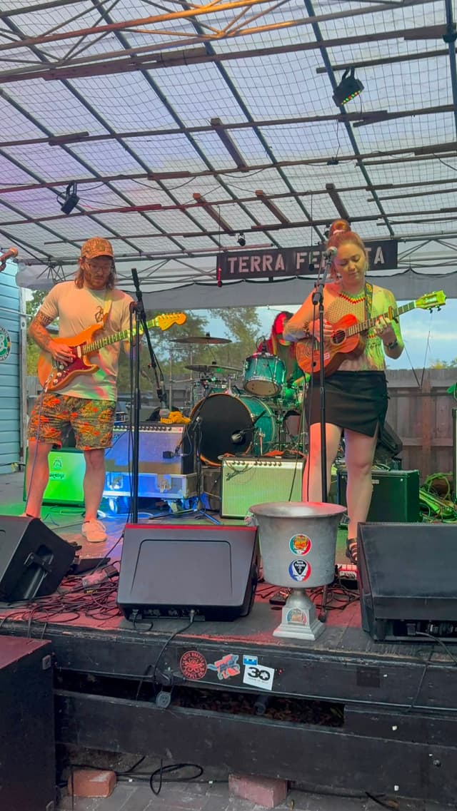 Mad Mellow’s guitarist and singer sharing a song on stage at Terra Fermata