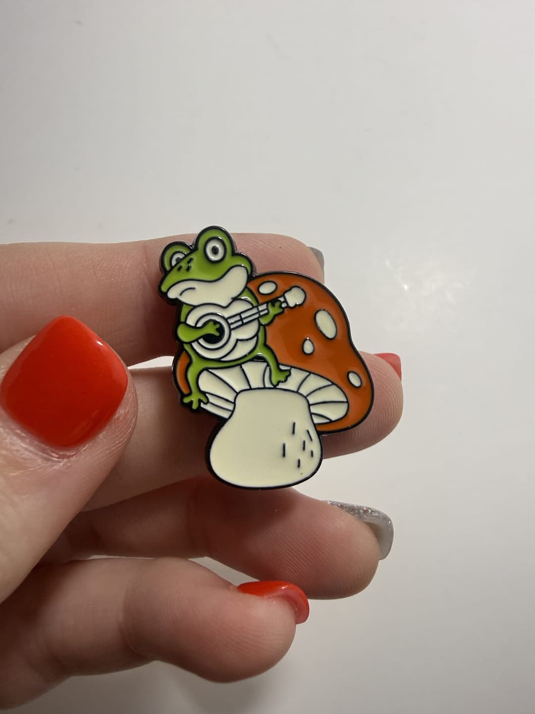 Frog Playing Guitar on Mushroom Enamel Pin — photo 1