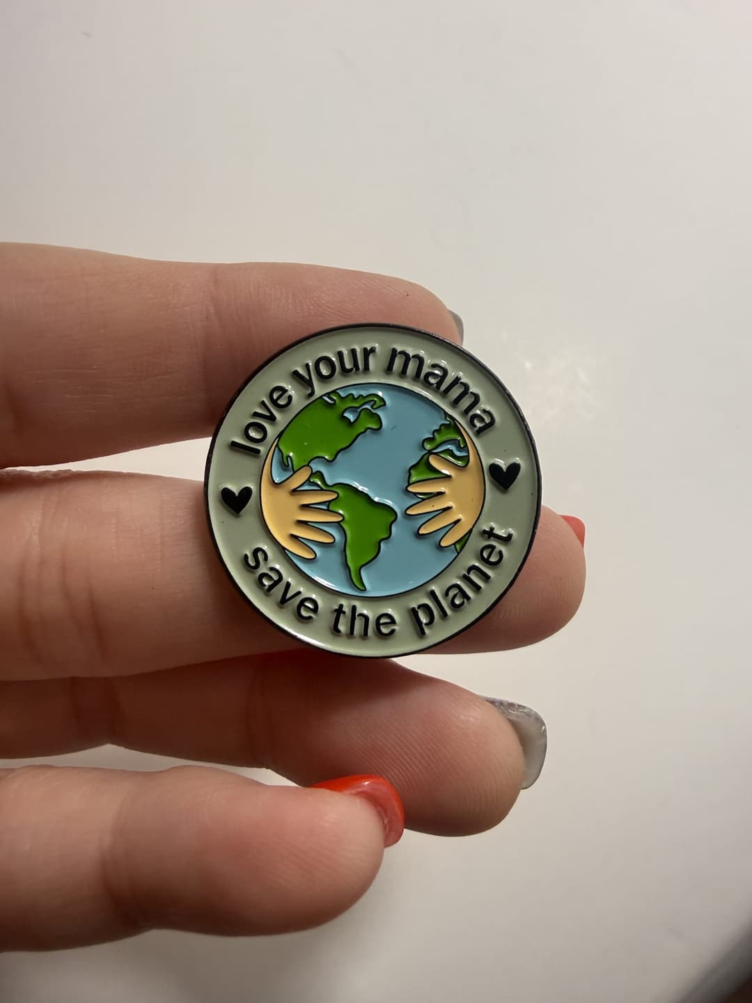 "Love Your Mama, Save the Planet" Earth Hug Enamel Pin — photo 1