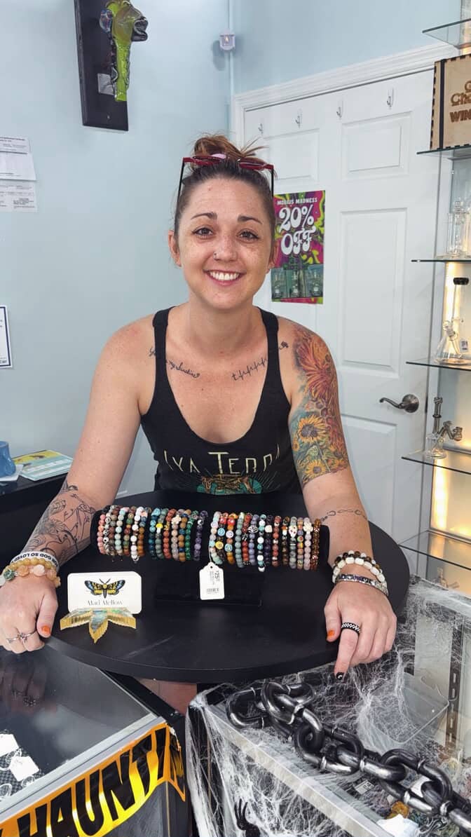 Emily, the founder of Mad Mellow, behind the pop-up counter with a display of handmade bracelets