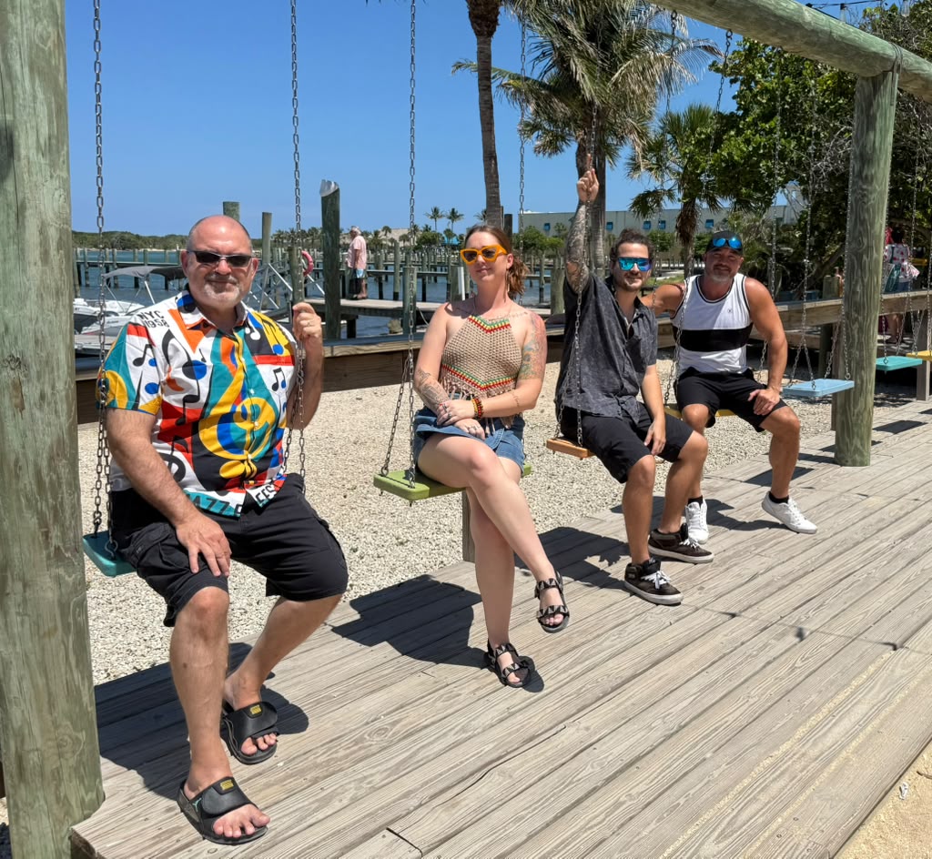 The whole Mad Mellow crew hanging out together on the dock swings in Florida